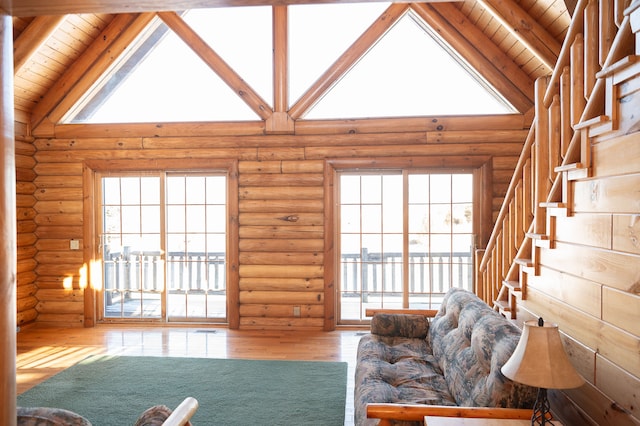 unfurnished living room featuring high vaulted ceiling, beam ceiling, and wood ceiling