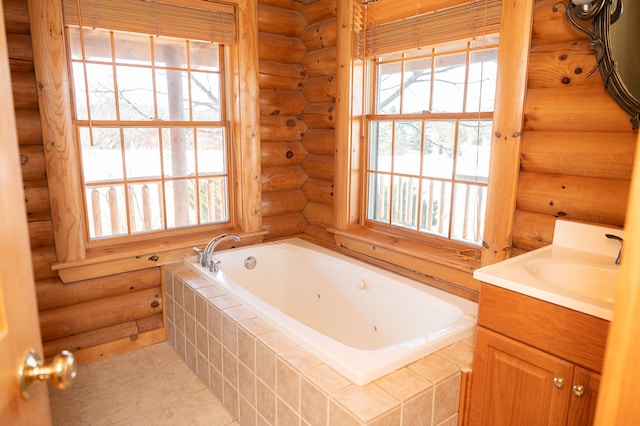 bathroom with tile patterned flooring, rustic walls, a jetted tub, and vanity