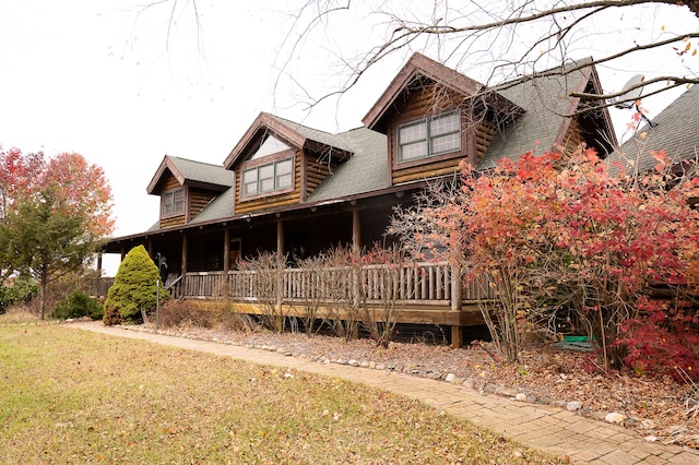 back of house with a porch and a yard