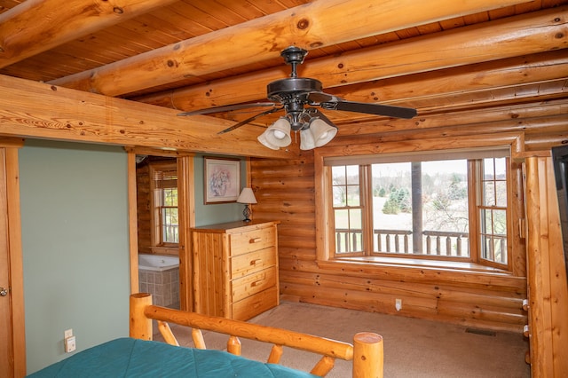 unfurnished bedroom with visible vents, rustic walls, and beam ceiling