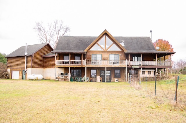 rear view of house with log exterior and a lawn