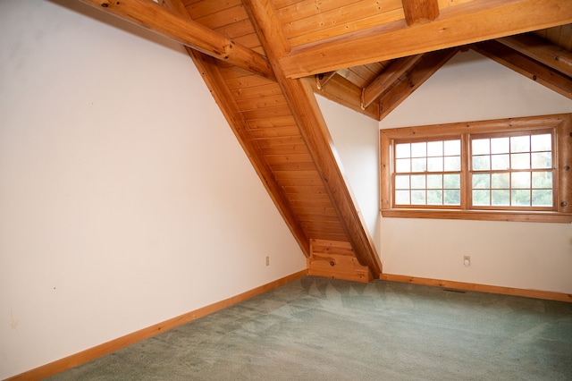 carpeted empty room with wood ceiling, lofted ceiling with beams, and baseboards