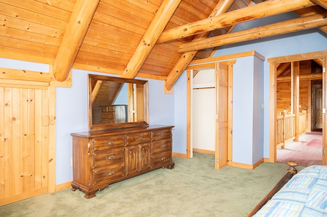 bedroom featuring lofted ceiling with beams, wooden ceiling, baseboards, and light colored carpet