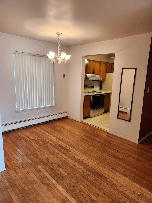 interior space with white range with electric stovetop, light wood-style floors, light countertops, under cabinet range hood, and a baseboard heating unit