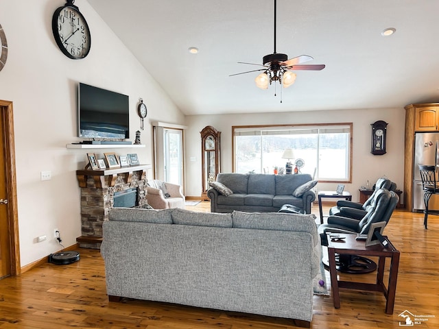 11799 Greenbriar Dr, Jerome, MI 49249 - living room featuring ceiling fan, lofted ceiling, light wood-style floors, recessed lighting, and a fireplace