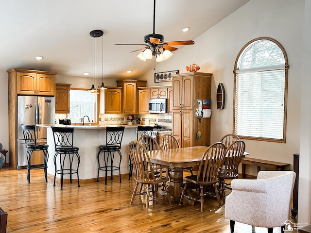 dining space with vaulted ceiling, ceiling fan, light wood finished floors, and recessed lighting