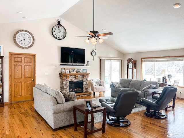 11799 Greenbriar Dr, Jerome, MI 49249 - living room featuring lofted ceiling, ceiling fan, light wood-style floors, and a fireplace