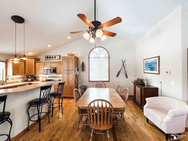 11799 Greenbriar Dr, Jerome, MI 49249 - dining area featuring a ceiling fan, vaulted ceiling, light wood finished floors, healthy amount of natural light, and recessed lighting