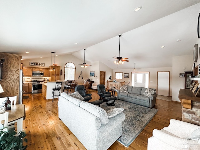 living room featuring light wood-type flooring, recessed lighting, a ceiling fan, and lofted ceiling