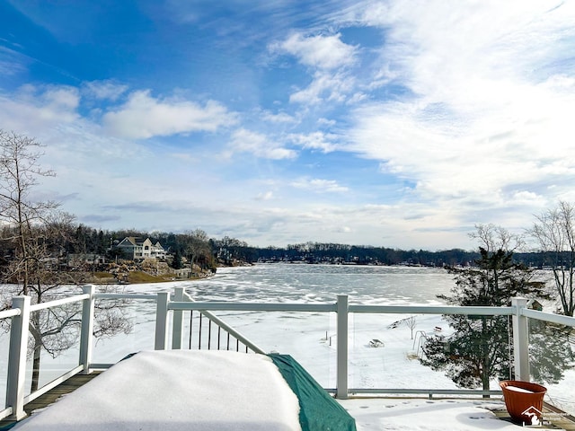 view of snow covered back of property