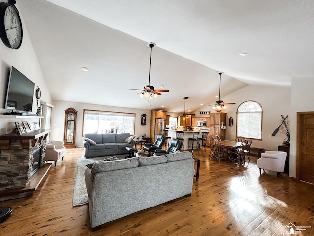 living room with high vaulted ceiling, hardwood / wood-style flooring, and a ceiling fan