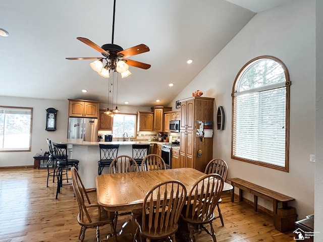 dining room featuring lofted ceiling, recessed lighting, ceiling fan, light wood-type flooring, and baseboards