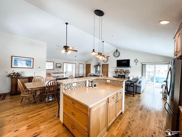 11799 Greenbriar Dr, Jerome, MI 49249 - kitchen with open floor plan, lofted ceiling, freestanding refrigerator, light wood-type flooring, and ceiling fan