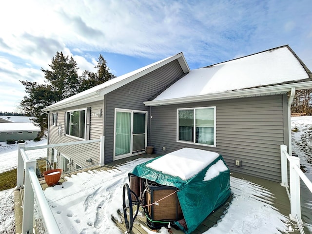 view of snow covered back of property