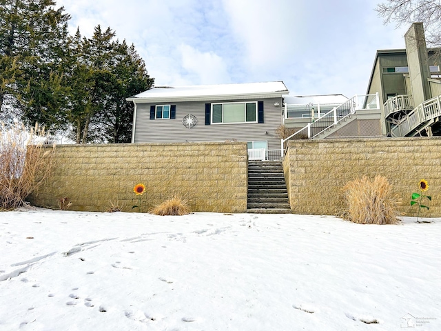 view of front of property with stairs and fence