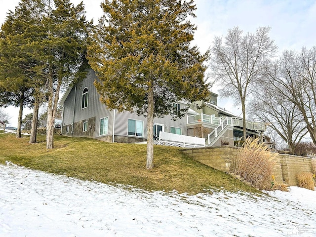 view of front of property with stairway and a lawn