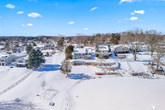 snowy aerial view featuring a residential view