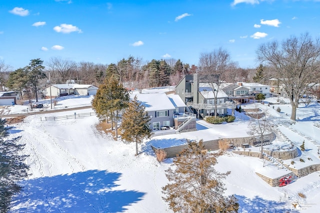 snowy aerial view with a residential view