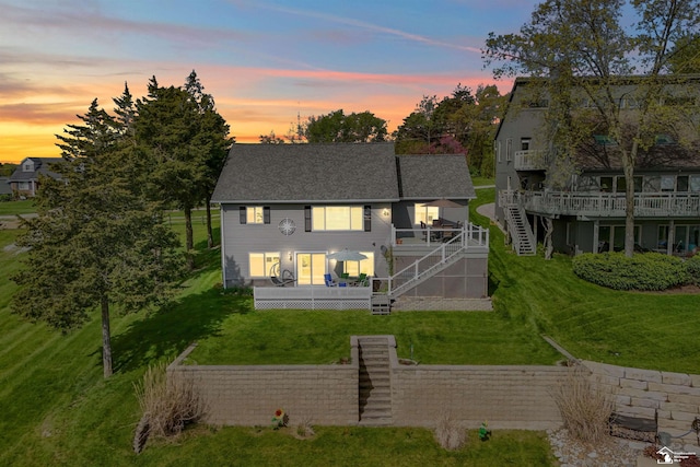 11799 Greenbriar Dr, Jerome, MI 49249 - rear view of house featuring stairway, a deck, a yard, and roof with shingles
