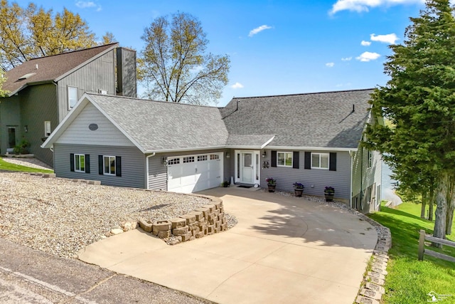 11799 Greenbriar Dr, Jerome, MI 49249 - view of front of home featuring a shingled roof, a garage, and driveway