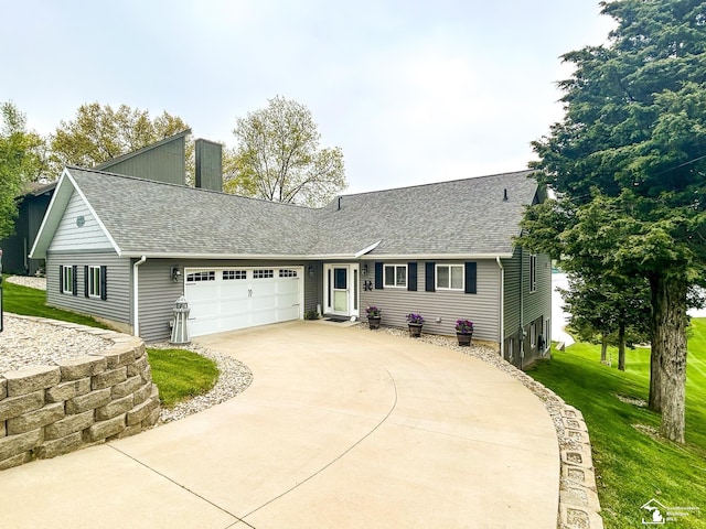 11799 Greenbriar Dr, Jerome, MI 49249 - view of front of home with an attached garage, a shingled roof, concrete driveway, and a front yard