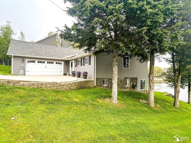 11799 Greenbriar Dr, Jerome, MI 49249 - view of front of home featuring an attached garage, a front lawn, and concrete driveway