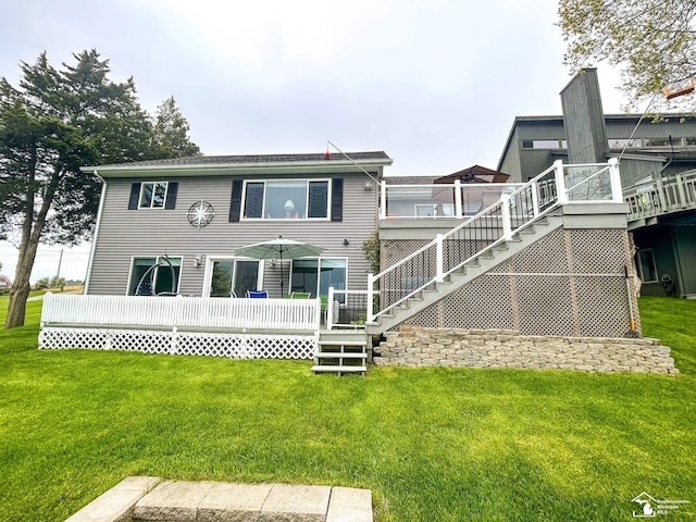 11799 Greenbriar Dr, Jerome, MI 49249 - rear view of house featuring a wooden deck, a lawn, and stairs