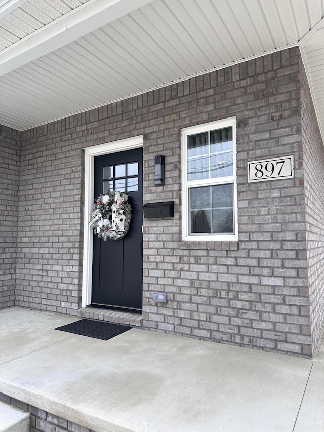 property entrance with brick siding