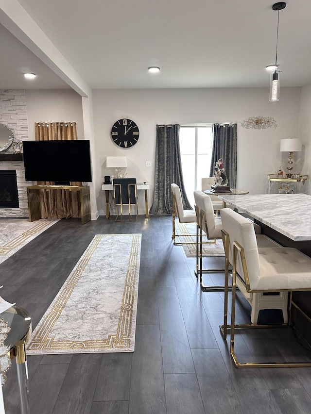 dining space with a fireplace and wood finished floors