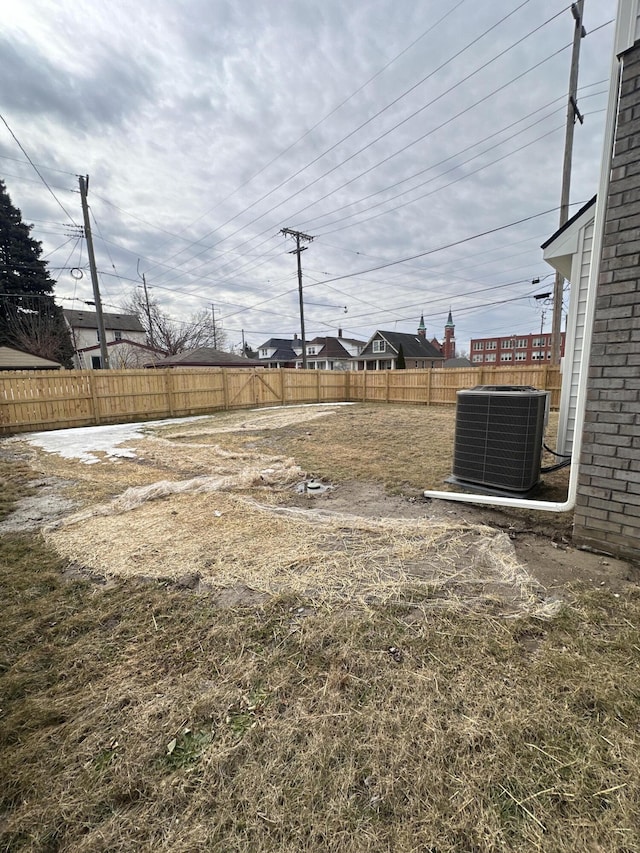 view of yard with cooling unit and fence