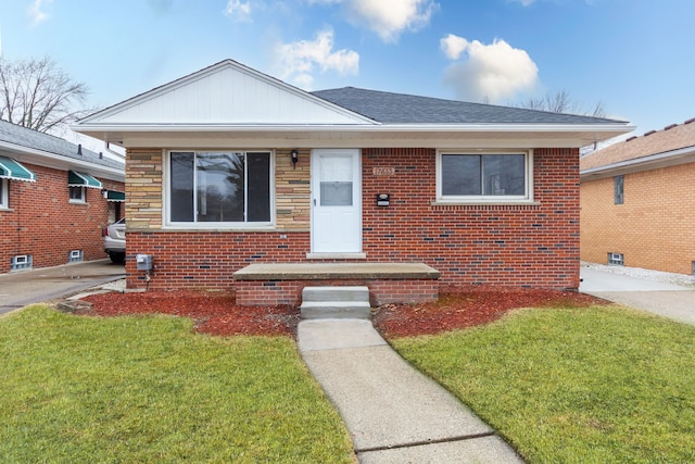 bungalow with brick siding, roof with shingles, and a front yard