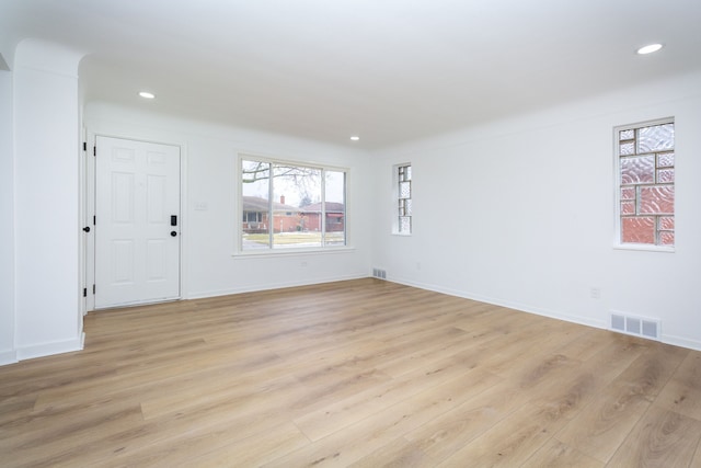 interior space with recessed lighting, baseboards, visible vents, and light wood finished floors