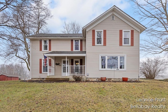 traditional-style house featuring covered porch and a front lawn