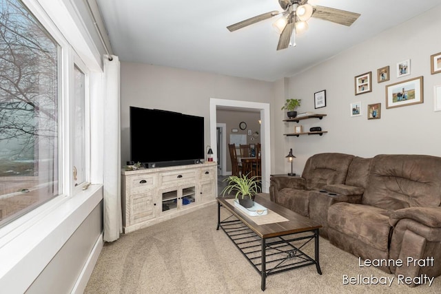 living room featuring carpet floors and a ceiling fan