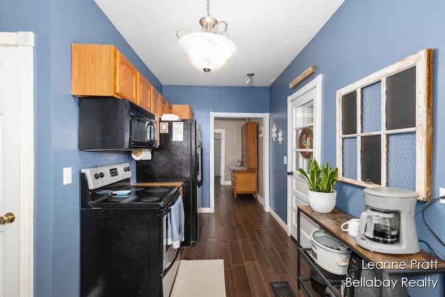 kitchen featuring stainless steel range with electric stovetop, baseboards, black microwave, and wood finish floors