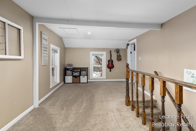 hallway with carpet, baseboards, lofted ceiling with beams, and an upstairs landing