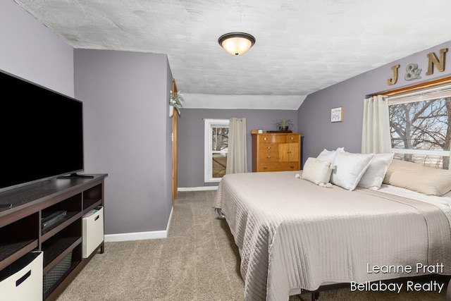 bedroom featuring vaulted ceiling, carpet, and baseboards