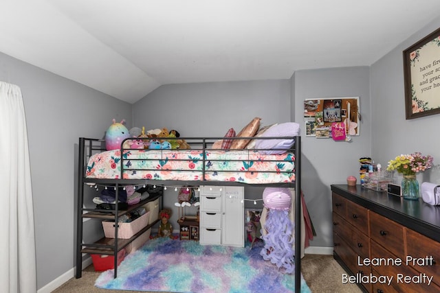 carpeted bedroom featuring lofted ceiling and baseboards