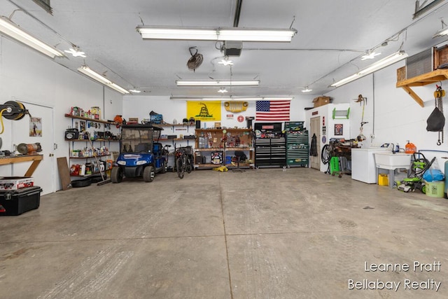 garage with a workshop area and a garage door opener