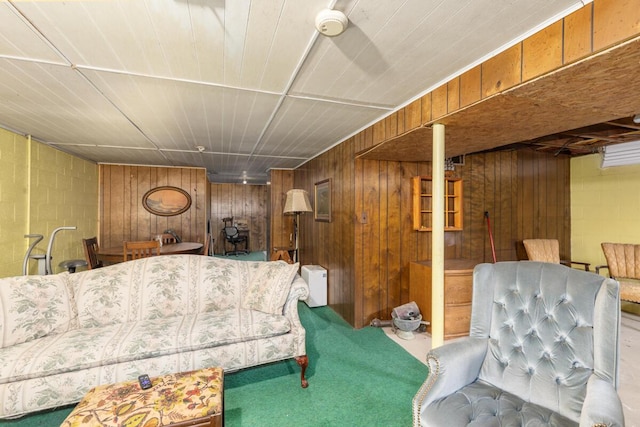 carpeted living room featuring concrete block wall and wooden walls