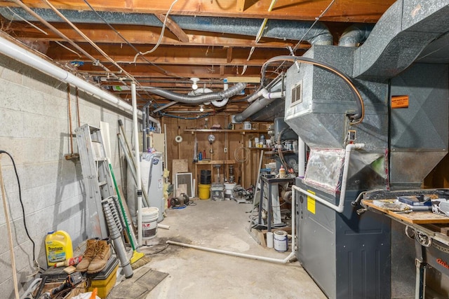 unfinished below grade area with concrete block wall, water heater, and heating unit