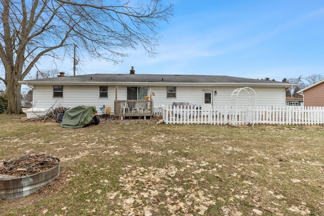 back of house featuring fence and a deck