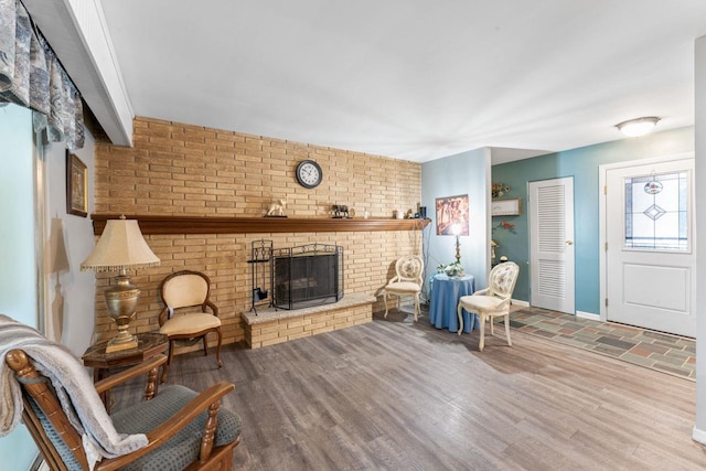 interior space featuring a fireplace, baseboards, and wood finished floors