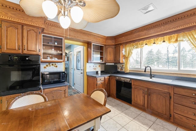 kitchen featuring brown cabinetry, black appliances, open shelves, a sink, and light tile patterned flooring