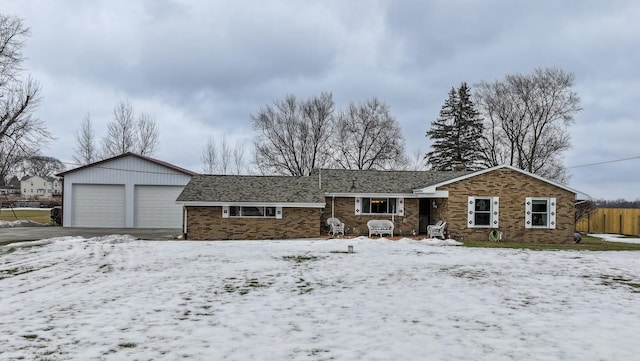 ranch-style home featuring a garage and brick siding