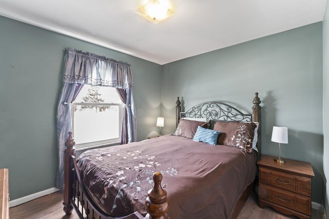 bedroom featuring baseboards and wood finished floors