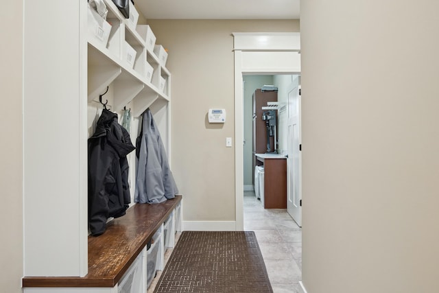 mudroom with light tile patterned flooring and baseboards