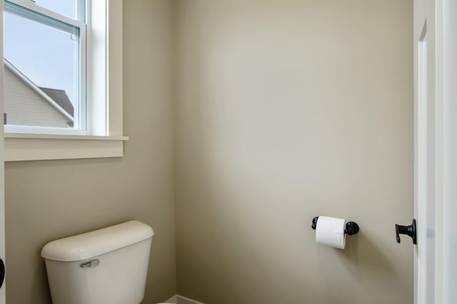 bathroom with toilet and a healthy amount of sunlight