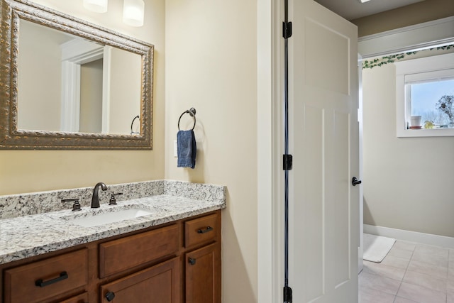 bathroom featuring tile patterned floors, vanity, and baseboards