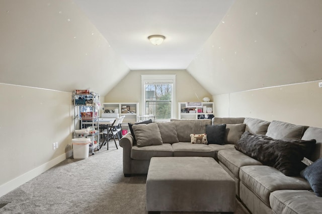 carpeted living room featuring baseboards and vaulted ceiling